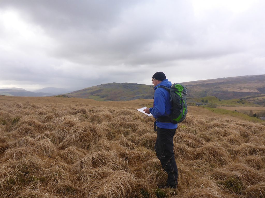 A man navigating his way through the Brecon Beacons