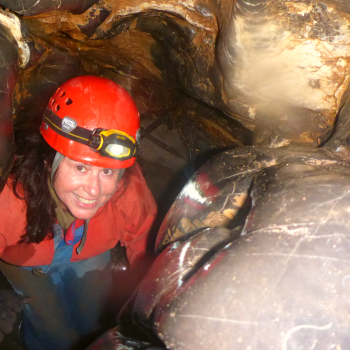 A lady smiling while caving