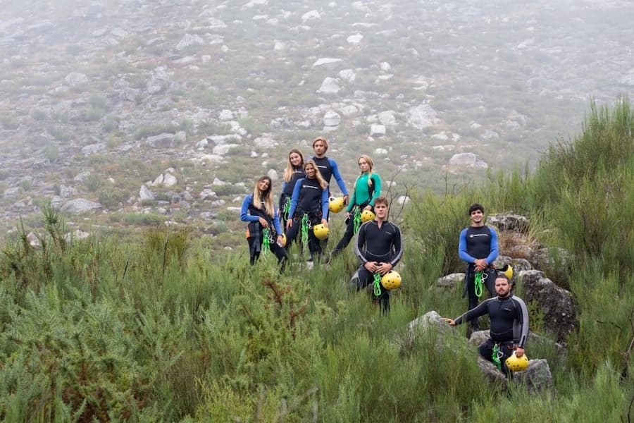 A group of people in wet suits posing for a photo