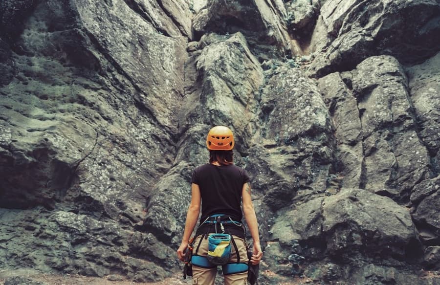 A person wearing a helmet and climbing gear