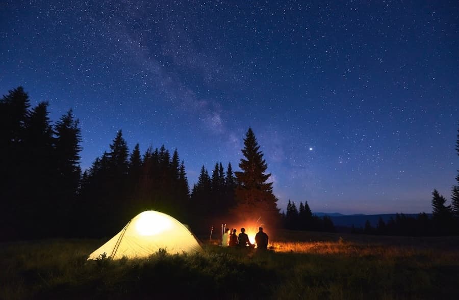 A group of people sitting around a campfire