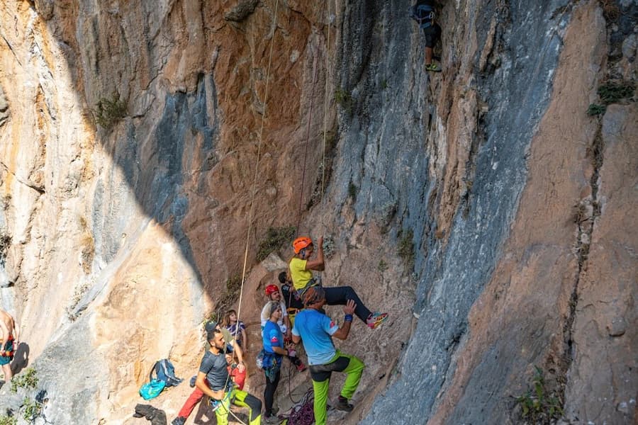 A group of people climbing a rock wall