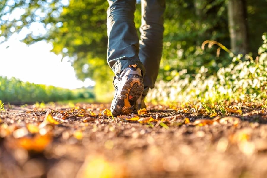 A person's feet walking on a path