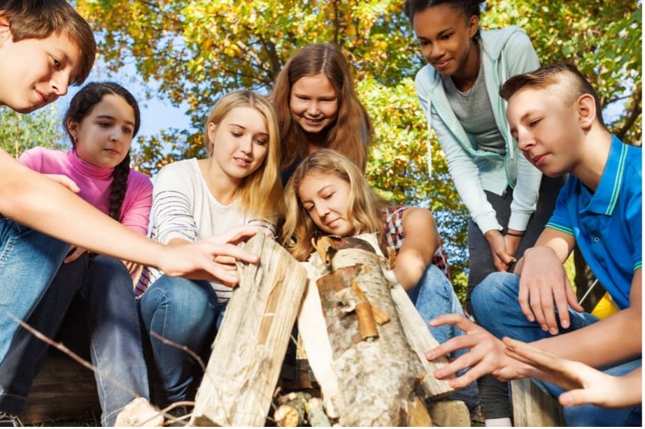 A group of young people around a fire