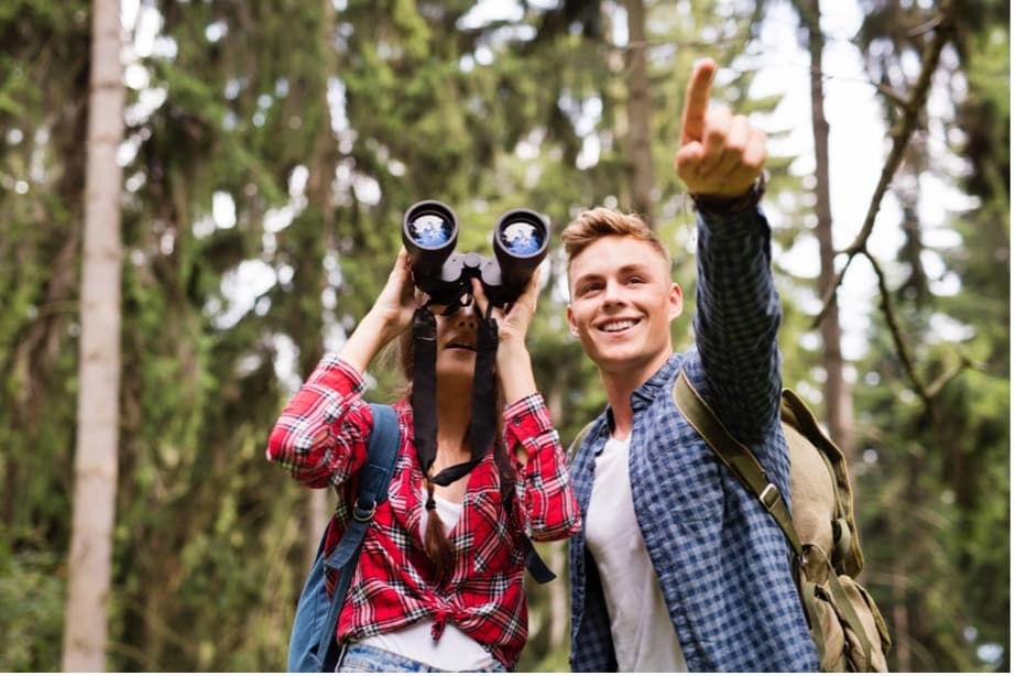 A person and person looking through binoculars